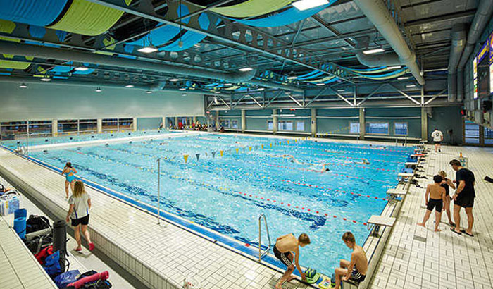 Swimmer in a well-lit indoor pool Veenendaal Swimmingpool